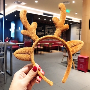 Close-up of brown plush reindeer antler headband with soft faux fur ears for Christmas