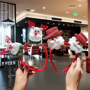 Detail of Christmas headbands featuring cute reindeer and Santa Claus plush figurines