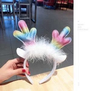Detailed view of sequined reindeer antlers headband with rainbow colors and faux fur