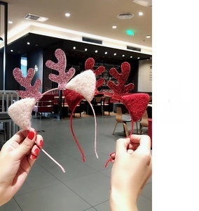 Close-up of red and pink sequined Christmas reindeer antler headbands with plush ears