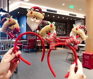 Detail view of four festive Christmas headbands with plush Santa, reindeer and snowman decor