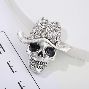 Macro detail of a vintage skull brooch with sparkling rhinestones and silver finish