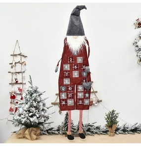 Close-up of burlap Christmas gnome advent calendar with numbered countdown pockets