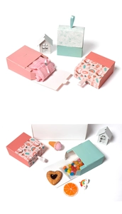 Pink and mint green drawer-style gift boxes with floral and beach patterns and fabric