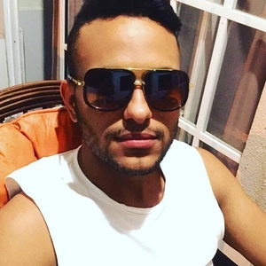 Close-up of oversized gold-framed sunglasses featuring a double-bridge metal design