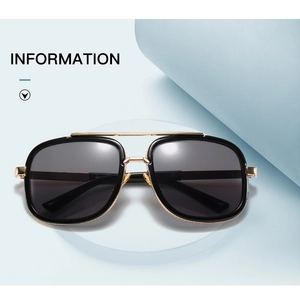 Close-up of retro aviator sunglasses with gold metal double bridge and black frame