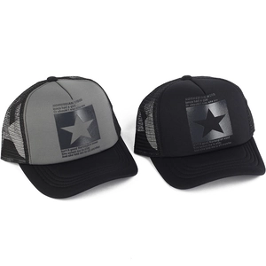 Close-up of black mesh trucker hats with star patterns and printed English lyrics