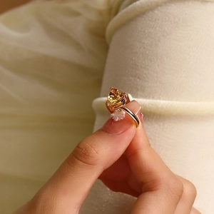 Macro shot of 18k gold-plated ring featuring a sparkling heart-shaped yellow zircon gem