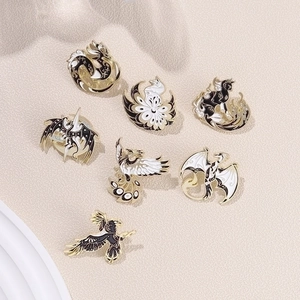 Detailed macro view of 7 black and white enamel badges with mythical dragon patterns