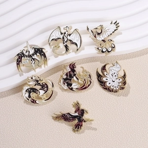 Mythical enamel pins collection featuring golden-lined dragon and phoenix motifs