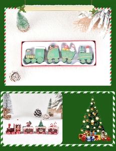 Detail of wooden Christmas train set with snowman and tree motifs in festive gift packaging