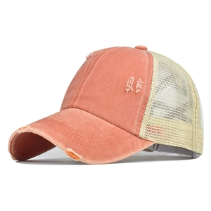 Gros plan sur casquette corail usée avec filet arrière et détails de déchirures