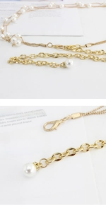 Detail showing elegant gold chain waist belt with pearlescent beads and lobster clasp
