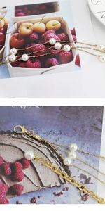 Detailed close-up of multilayer pearl waist chain with gold clasp and lobster hook