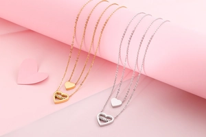 Detailed comparison of gold and silver heart necklaces with mom cut-out design