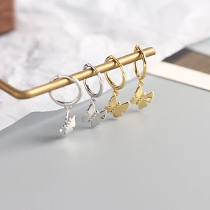 Detailed view of 925 sterling silver butterfly drop earrings in gold and silver finishes