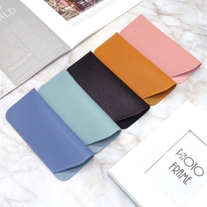 Litchi texture PU leather sunglasses pouches in five colors shown on marble surface