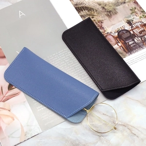 Close-up of litchi texture PU leather sunglasses pouches in navy blue and black colors