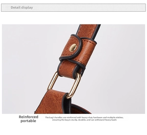 Detail of reinforced stitching and gold metal ring on a vintage brown leather tote bag