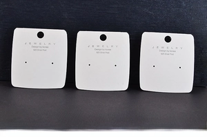 Three white jewelry display cards for earrings and necklaces, size 5.5x6cm on blue background