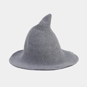 Detail of grey knitted witch hat showing coarse knit texture and pointed top design