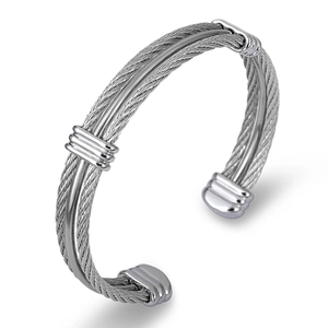 Detailed macro view of triple-strand silver braided steel cable bracelet with polished rings
