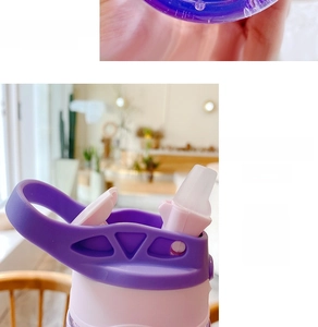Detail of baby plastic cup featuring one-click flip lid and soft silicone straw