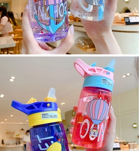 Detail of colorful kids plastic water bottles with straw, handles and cartoon patterns