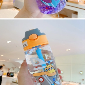 Detail of clear plastic kids straw bottle with cartoon submarine and push-button lid