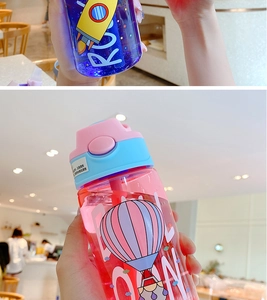 Detail of portable kids plastic cup showing secure lock, straw lid and carry loop