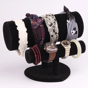 Detail of a two-tier black velvet jewelry display stand with headbands and bracelets