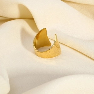 Macro view of 18K gold plated hammered texture adjustable ring on white silk background