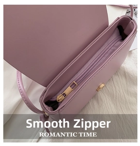 Detail of light purple shoulder bag showing the smooth zipper and golden magnetic buckle