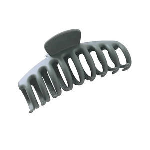 Detail showing matte gray plastic large claw clip with multi-tooth design on white background