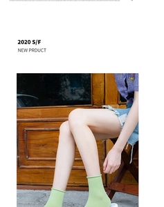 Detail of light green thin slouch socks with stylish rolled cuffs for women