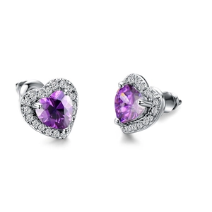 Macro shot of silver heart earrings with purple zirconia and white pavé halo