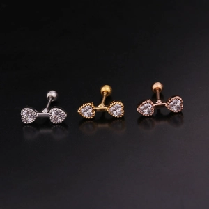 Detailed view of three heart-shaped stud earrings in silver, gold, and rose gold finishes