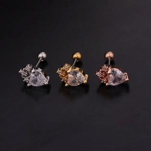 Detailed view of heart-shaped zircon stud earrings in silver, gold, and rose gold finishes
