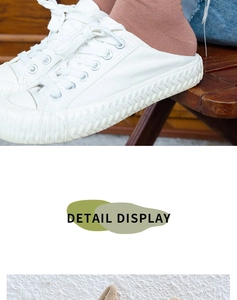 Detailed close-up of white canvas sneakers showing the wave-textured sole and lace-up design