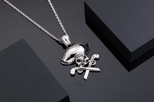 Detailed macro shot of silver pirate skull and crossed pistols pendant on twist chain