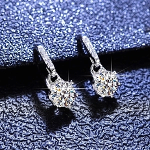 Macro shot of S925 sterling silver snowflake moissanite earrings with brilliant sparkle
