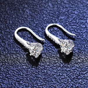 Detailed macro view of S925 sterling silver snowflake earrings with round moissanite stones