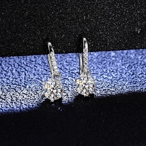 Macro detail of snowflake moissanite earrings in S925 sterling silver with round cut stones