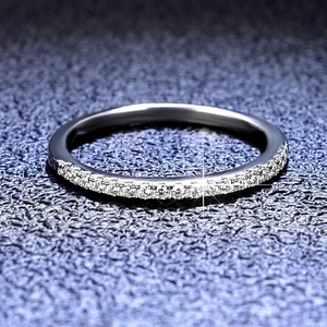 Moissanite 925 silver ring featuring a single row of sparkling pavé set stones on blue background