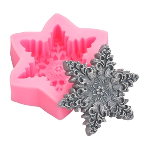Pink silicone snowflake soap mold with a detailed 3D white embossed snowflake craft sample