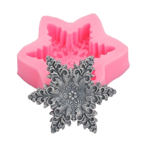 Pink snowflake silicone DIY mold and finished grey handmade soap relief on white background