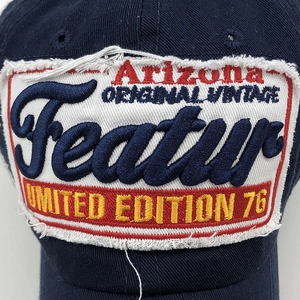 Macro detail of navy washed cotton baseball cap with vintage distressed embroidery patches