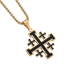 Close-up of gold stainless steel necklace featuring a black enamel cross pendant details