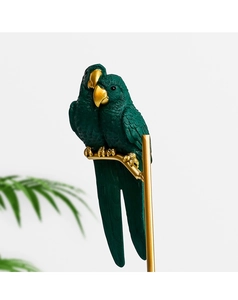 Detailed view of resin parrot statue featuring fine feather texture and gold accents
