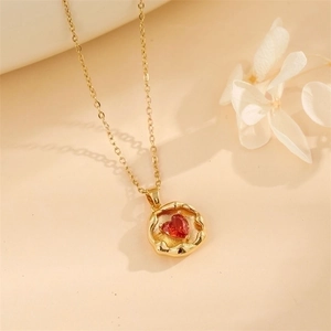 Golden titanium steel necklace with an irregular round pendant and red heart zircon stone
